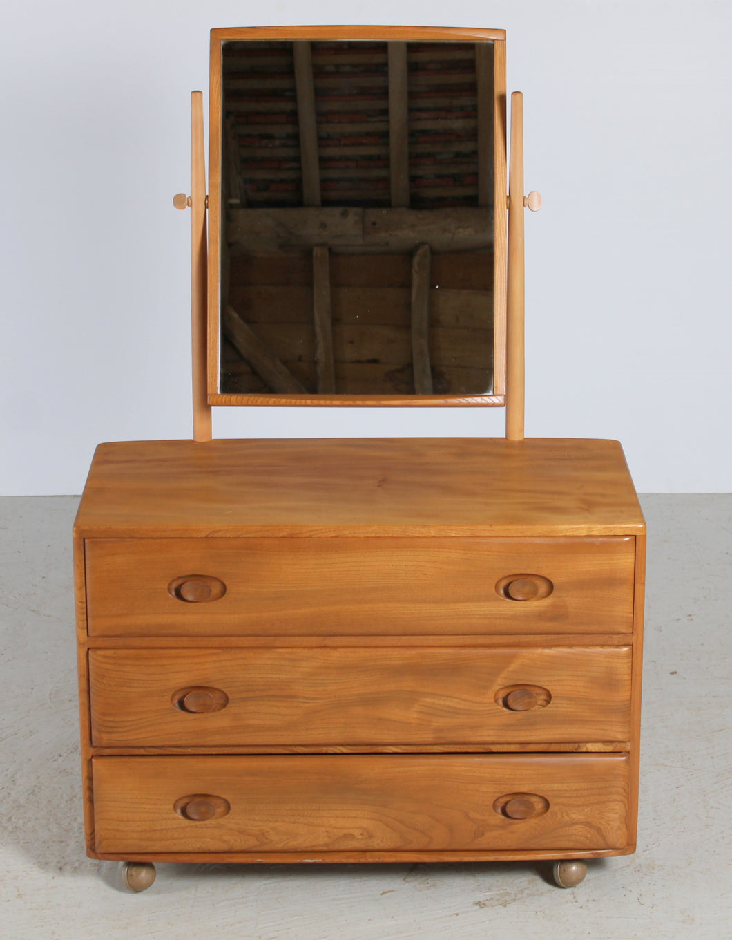 Mid Century Ercol Windsor Model 483 Vanity Chest Of Drawers With Mirror, circa 1960s.